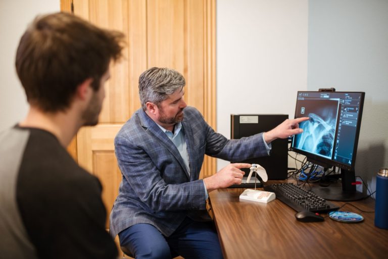 Doctor showing a patient images on a screen